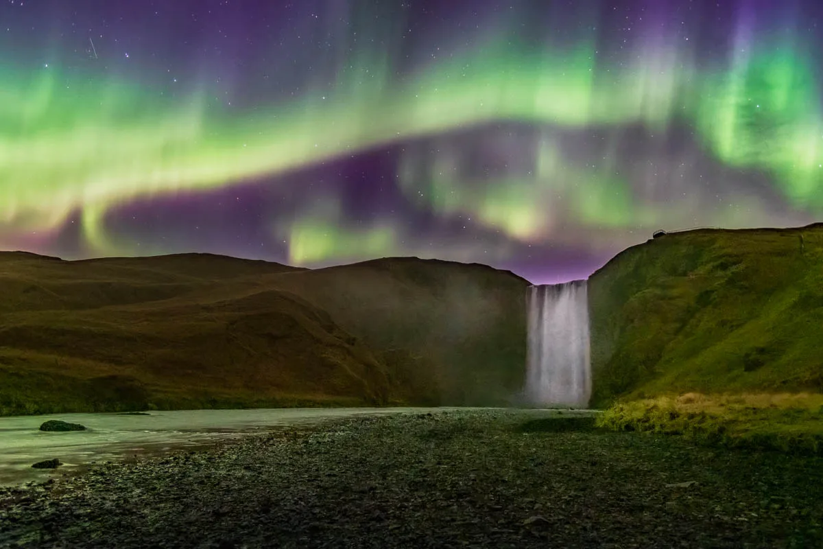 APOD: 2026 August 27 – Colorful Aurora over an Icelandic Waterfall